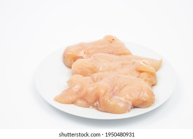 Raw Chicken Breasts On The Plate Above White Background.