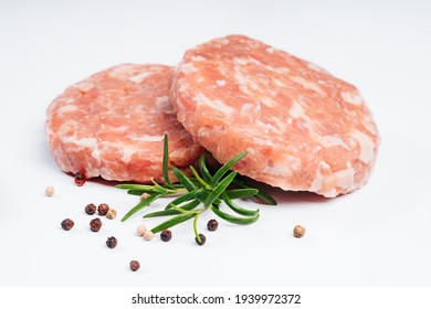 Raw Chicken Burger On A White Plate In A Rosemary Branch And Spices. Instant Meat. Grilled Hamburgers.Raw Hamburger, Meatballs On White Background.Fast Food At Home.Convenience Food, Precooked.