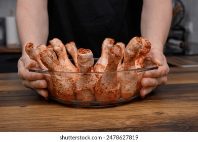 Raw chicken drumsticks in an ovenproof dish