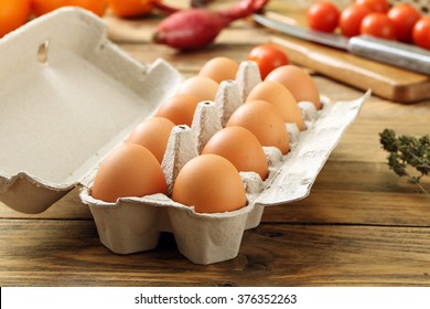 raw chicken Eggs in the package rustic background