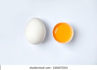 Raw Chicken Eggs With Yolk On White Background, Top View