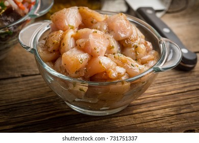 Raw Chicken Fillet Breast Cut Into Pieces And Spiced In Glass Bowl. Small Depth Of Field.