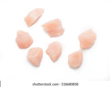 Raw Chicken Fillet. Small Pieces Of Meat Isolated On White. Top View.