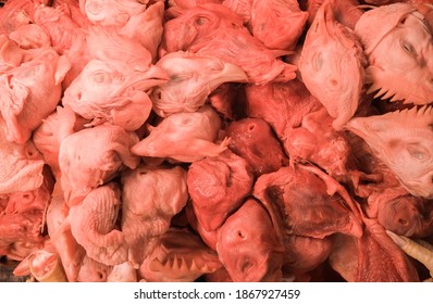 Raw Chicken Heads On A Store Counter Close Up