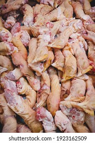 Raw Chicken Heads On Store Counter Close Up. Vertical Orientation