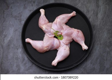 Raw  Chicken Leg Or Chicken Thigh Without Skin Beautifuly Arranged In A Black Round Tableware On Grey Or Graphite Texture