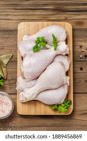 Raw chicken legs on wooden background. Top view, flat lay, space for text.