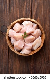 Raw Chicken Meat In Bowl Over Wooden Background, Top View.