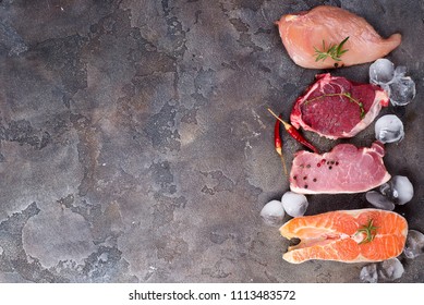 Raw Chicken, Meat And Fish With Ice And Spices Isolated On Stone. Lean Proteins.