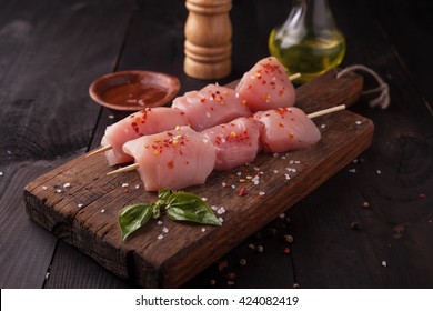 Raw Chicken Shish Kebab On Skewers With Spices On A Wooden Background