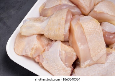 Raw Chicken Tender Curry Cut With Skin Arranged On White Plate  With Grey Background, Closeup.