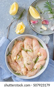 Raw Chicken Tenders Marinated With Garlic, Olive Oil, Lemon Juice, Rosemary, Thyme, Salt And Pepper