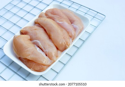 Raw Chicken Tenders On White Background.