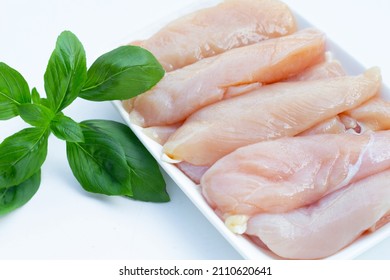 Raw Chicken Tenders On White Background.