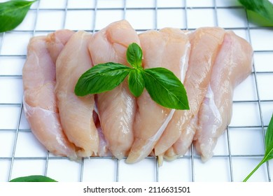 Raw Chicken Tenders On White Background.