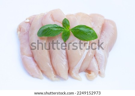 Raw chicken tenders on white background.
