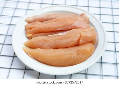 Raw Chicken Tenders In White Plate