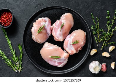 Raw Chicken Thigh Fillet Without Skin. Farm Poultry Meat. Black Background. Top View