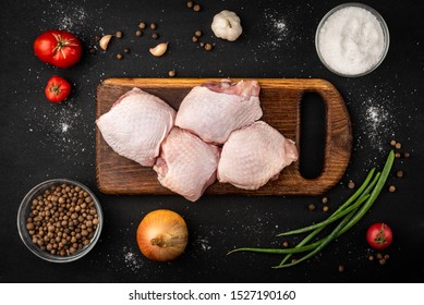 Raw Chicken Thigh On Black Background.