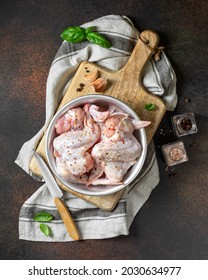 Raw Chicken Wings In A Metal Bowl On A Wooden Board On A Dark Culinary Background Top View. The Process Of Cooking Poultry