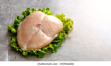 Raw chickenbreast and leg on the grey backgrond.