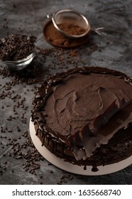 Raw chocolate cheesecake on dark grey background. Healthy organic dessert pie. Cacao and chocolate around - Shutterstock ID 1635668740