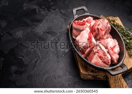 Raw chopped lamb meat with bones, uncooked mutton ready for cooking. black background. top view.
