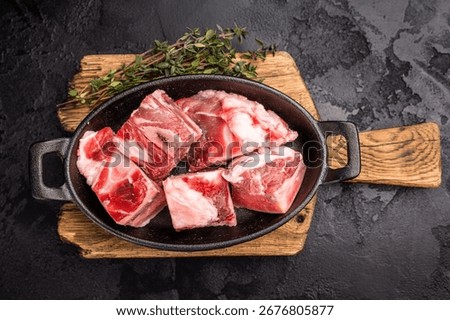Raw chopped  lamb meat with bones, uncooked mutton ready for cooking. black background. top view.