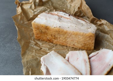 Raw chopped pork lard with meat on a gray background for copy space. A large chunk of fresh fat. Ukrainian lard, traditional food.