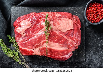 Raw Chuck Eye Roll Steak. Organic Beef. Black Background. Top View