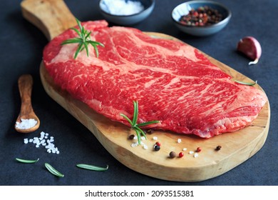 Raw Chuck Eye Steak On Wooden Board