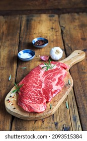 Raw Chuck Eye Steak On Wooden Board