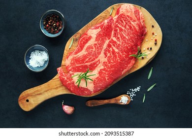 Raw Chuck Eye Steak On Wooden Board