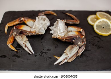 Raw, Cleaned, Uncooked Dungeness Crab Legs Sit On A Platter In The Kitchen Ready To Be Cooked For Dinner