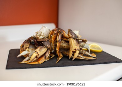 Raw, Cleaned, Uncooked Dungeness Crab Legs Sit On A Platter In The Kitchen Ready To Be Cooked For Dinner