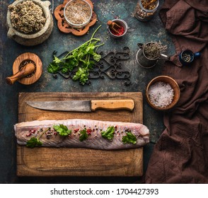 Raw Coal Fish Fillet On Wooden Cutting Board With Knife, Top View. Preparation Of Home Fish Cooking With Herbs And Spices. Healthy Sea Food 