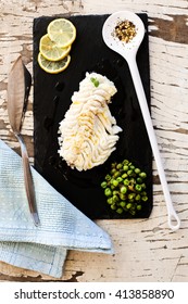raw cod fillet over slate