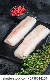 Raw Cod Loin Fillet Fish On Marble Board. Black Background. Top View