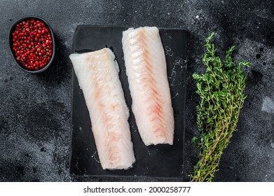 Raw Cod Loin Fillet Fish On Marble Board. Black Background. Top View