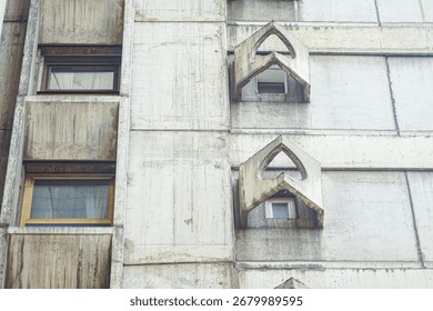 Raw concrete façade with angular brutalist windows. Close-up of the Genex Tower in Belgrade. Concepts of architectural details, modern heritage, urban design. Brutalist architecture as visual poetry 