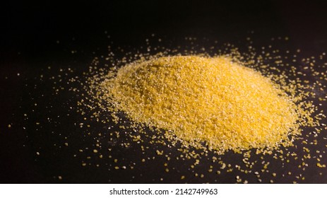 Raw Corn Grits Flour On Black Background