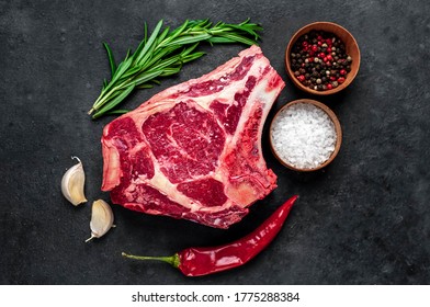 Raw cowboy steak. Marbled beef meat 
with spices on a stone background - Shutterstock ID 1775288384
