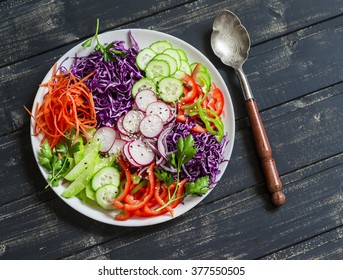 Raw Crunchy Colorful Coleslaw Salad With Red Cabbage, Radish, Cucumber, Sweet Peppers, Carrots, Parsley And Sesame Seeds. Healthy Vegetarian Food