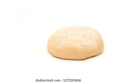 Raw Dough Lying On The Table On A White Background. A Piece Of Dough For Bread Baking. Pasta Dough.