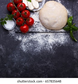 Raw Dough For Pizza With Ingredients And Spices On Black Background.overhead With Copy Space