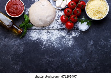 Raw Dough For Pizza With Ingredients And Spices On Black Background.overhead With Copy Space