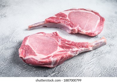 Raw Dry Aged Tomahawk Pork Chop Steak. White Background. Top View.