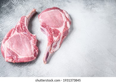 Raw Dry Aged Tomahawk Pork Chop Steak. White Background. Top View. Copy Space.