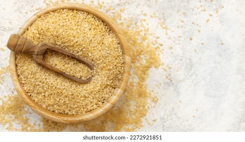 Raw Dry bulgur wheat grain on a white plate on a table  top view, copy space. Vegetarian and Vegan, Mediterranean and Middle Eastern cuisine. Healthy lifestyle - Powered by Shutterstock