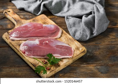 Raw Duck Meat On A Wooden Board